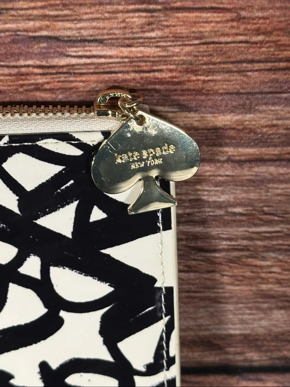 Kate Spade New York pouch features a whimsical 